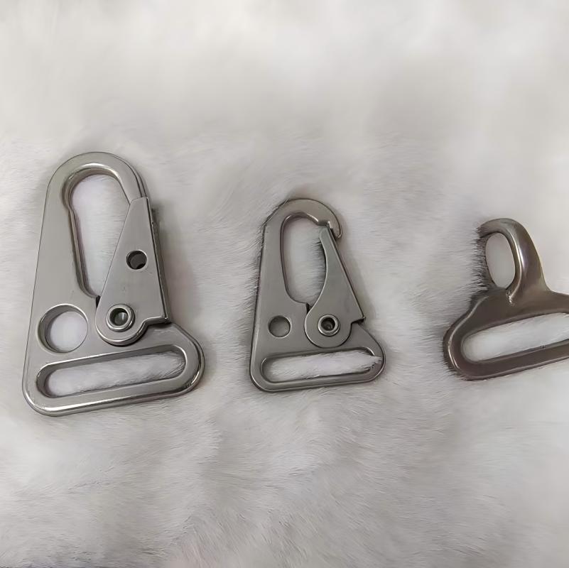 Close-up of a heavy-duty locking carabiner clipped onto a climbing harness, highlighting secure twist-lock mechanism